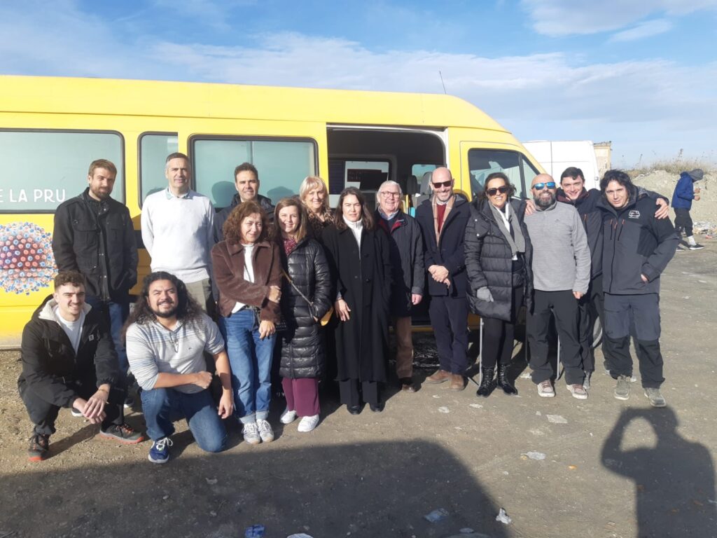MOBHOPE participants beside the yellow mobile screening unit during the field visit to Cañada Real, Madrid.